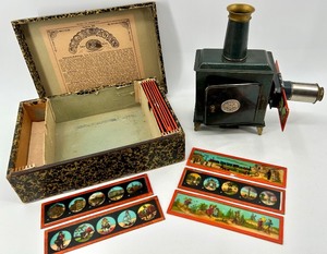 lot 6 image: Antique German Magic Lantern Projector with Original Glass Slides and Box