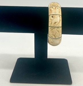 lot 49 image: Vintage Carved Bone and Brass Bangle Bracelet with Animal Motif