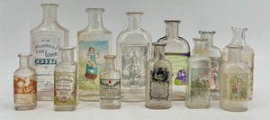 lot 114 image: Collection of 12 Antique Glass Water Slide Bottles with Original Labels