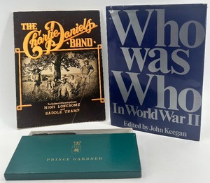 lot 193 image: Book Lot Who Was Who in World War II, Charlie Daniels Band Songbook, and Prince Gardner Wallet