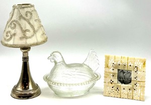 lot 324 image: Decorative Lot with Glass Hen Dish, Metal Tealight Lamp, and Nicole Miller Frame
