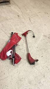 lot 37 image: Toro 8 Inch Cut Electric Trimmer and Red Folding Chair