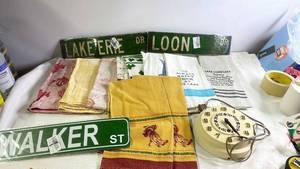 lot 219 image: Group of Vintage Kitchen Towels, Decorative Street Signs, and Rotary Wall Clock