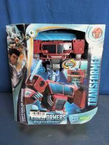 lot 38 image: Transformers EarthSpark Spin Changer Optimus Prime and Robby Malto action figure set.