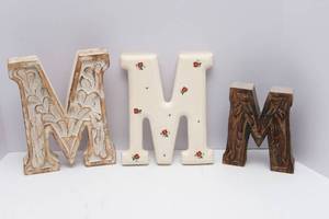 lot 132 image: Set of Three M Wall Hangings