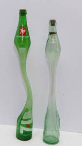 lot 169 image: Two Vintage Stretched Glass Pop Bottles  7Up & Coke