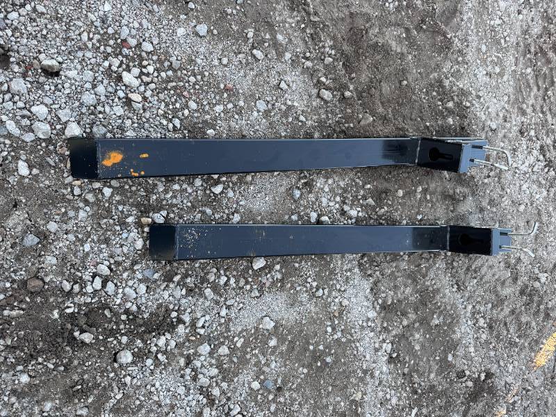 lot 106 image: 2025 Unused WOLVERINE Applicable products include tractor accessories, skid steer loaders, and loader buckets Non-adjustable clip-on pallet fork