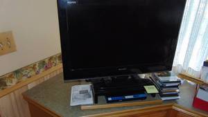 lot 120 image: 37 Sharp TV with Remote, Phillips DVD Player and Misc DVDS