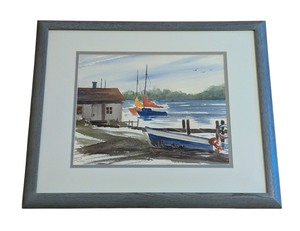 lot 56 image: ML - Framed Watercolor Painting by Betty D. Brown Featuring Boats and Lakeside Scene