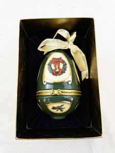 lot 100 image: Mr. Christmas Porcelain Hinged Egg Ornament with Wreath Design and Ribbon
