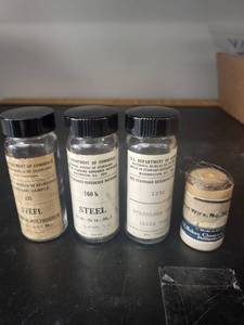 lot 84L image: Vintage Standard Reference Steel and Stainless Steel Sample Vials with Wire Spool