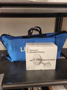 lot 96L image: Laerdal Little Junior CPR Manikin with Carry Bag and Resusci Manikin Faces Set
