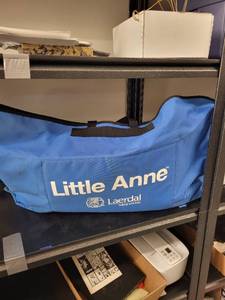 lot 97L image: Laerdal Little Anne CPR Training Manikin with Carry Bag