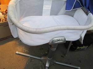 lot 106 image: Wide base swiveling Baby bassinet w...