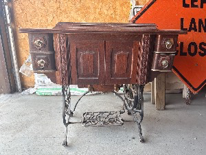lot 313 image: Antique Domestic Treadle Sewing Machine with Cabinet, Accessories, and Original Manual