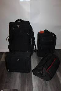 lot 10 image: Set of 4 Assorted Black Luggage Bags and Suitcases