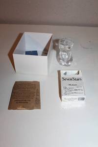 lot 34 image: Seven Stars Medium Cigarette Box, Glass Figure, and Welcome Packet Set