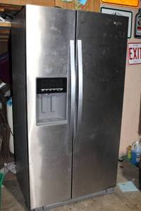 lot A-121 image: Whirlpool Side-by-Side Stainless Steel Refrigerator with Water and Ice Dispenser