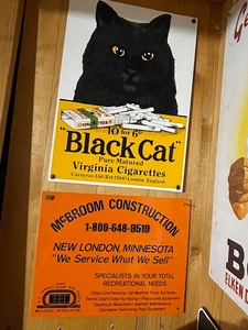 lot 129 image: Vintage Black Cat Virginia Cigarettes and McBroom Construction Metal Signs