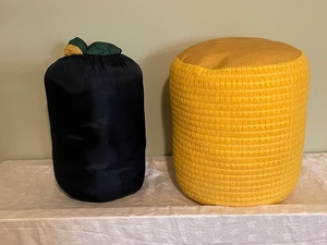 lot 24 image: Yellow Fabric Ottoman and Green Sleeping Bag with Stuff Sack