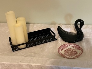 lot 25 image: Home Decor Collection with Black Swan Figurine, Decorative Plate, Candles, and Metal Tray