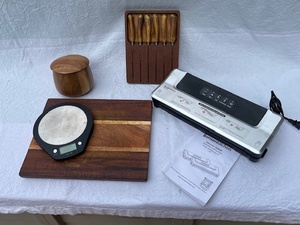 lot 83 image: Kitchen Essentials Bundle with Cutting Boards, Steak Knives, Digital Scale, Canister, and Vacuum Sealer