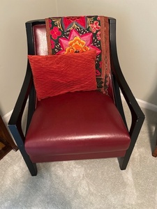 lot 103 image: Contemporary Red Faux Leather Accent Chair with Pillow and Embroidered Throw