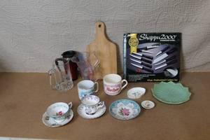 lot 24 image: Mixed Kitchenware Collection with Vintage Teacups, Measuring Cups, Knives, Mugs, and Glassware
