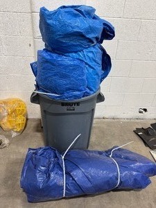 lot 37 image: Four Various Sized Blue Tarps with a Rubbermaid Brute Trash Can