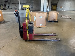 lot 76 image: 24 Volt Electric Pallet Jack.  Runs Great. Built in Charger.  Missing Front Cover.