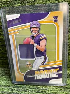 lot 192 image: 2024 Absolute JJ McCarthy Rookie Materials Jersey Relic