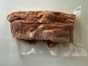 lot 85 image: BB. 2lbs OlSmokehouse Honey Orange Uncured Bacon Ends & Pieces
