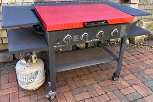 lot 166N image: Blackstone 4-Burner Outdoor Gas Griddle with Red Steel Cover and Side Shelves