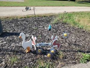 lot 23 image: Outdoor Spike Balls, Vintage Deer Welcome Sign, Plant Hangers and more