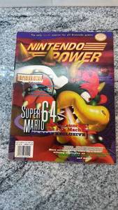 lot 135 image: Nintendo Power Magazine Issue Featuring Super Mario 64 and Turok Poster