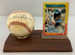 lot 71 image: Brooks Robinson Autographed Baseball With 1975 Topps Baseball Card On Stand