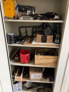 lot 130 image: Cabinet of Mixed Industrial Parts Including Oil Filters, Pistons, Bearings, and Hardware