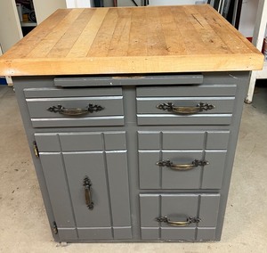 lot 132 image: Rolling Gray Wood Kitchen Island Cabinet with Drawers and Wood Top