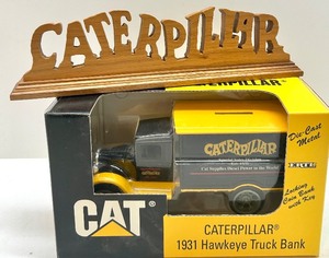 lot 58 image: Caterpillar 1931 Hawkeye Die-Cast Truck Bank and Wooden Sign