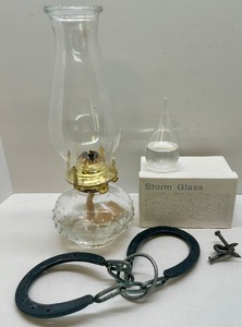 lot 71 image: Decorative Glass Oil Lamp, Storm Glass Weather Predictor, and Horseshoe Puzzle Set