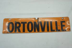 lot 442 image: Metal Ortonville Sign 17x4 Orange with Black Letters