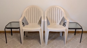 lot 87 image: LL - Pair of White Plastic Patio Chairs with 2 Glass Topped Side Tables