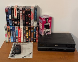 lot 151 image: LL - Magnavox VHS Player with Remote, Manual, and 20 VHS Tapes Collection