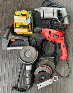 lot 299H image: GS - Power Tool Lot Black & Decker 4 12 Angle Grinder, Two Drills, Stanley Staple Gun, Staples and Grinding Wheels