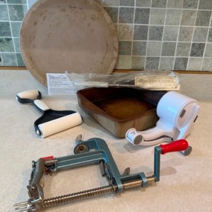 lot 49 image: Pampered Chef Items--Apple Slicer, Pans, Grease Mop, and Grinder