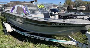 lot 8 image: 1992 Sylvan Sportster 19 runabout with Mercruiser 3.0L and roller trailer.  Fish and ski package with bimini and cover.  Tube and skis are included in sale.