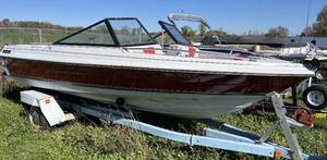lot 21 image: 1986 Sunbird 18 Runabout with Volvo V6 and Roller Trailer.  V-hull boat with open bow.