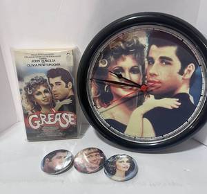 lot 77 image: 1978 Grease Paperback,  Grease Clock and Three Grease Buttons