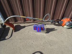 lot 110 image: Husquvarna 2 cycle weed trimmer. Used condition. Tested & works. As shown.