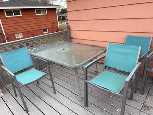 lot 1 image: Outdoor Patio Set with Glass Table and 4 Blue Mesh Chairs